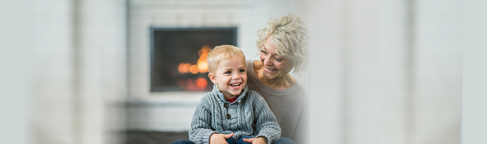 A mature woman and her grandson smile together with clarity in hearing and thinking